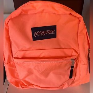 Bright coral/peach Jansport backpack with double zipper.